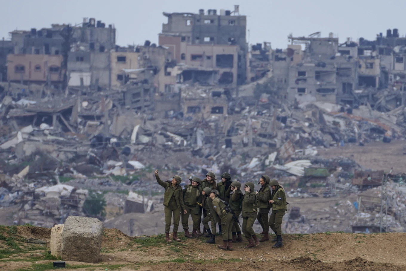 Israeli female soldiers pose for a photo on a position on the Gaza Strip, Feb. 19, 2024. AP Photo-Tsafrir Abayov